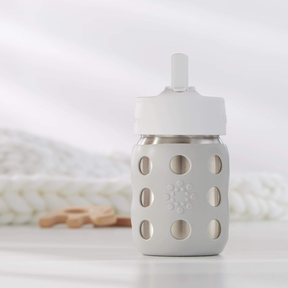Lifefactory Pivot Straw Cap white shown with a bottle, ergonomic grip and kid-friendly sipping.