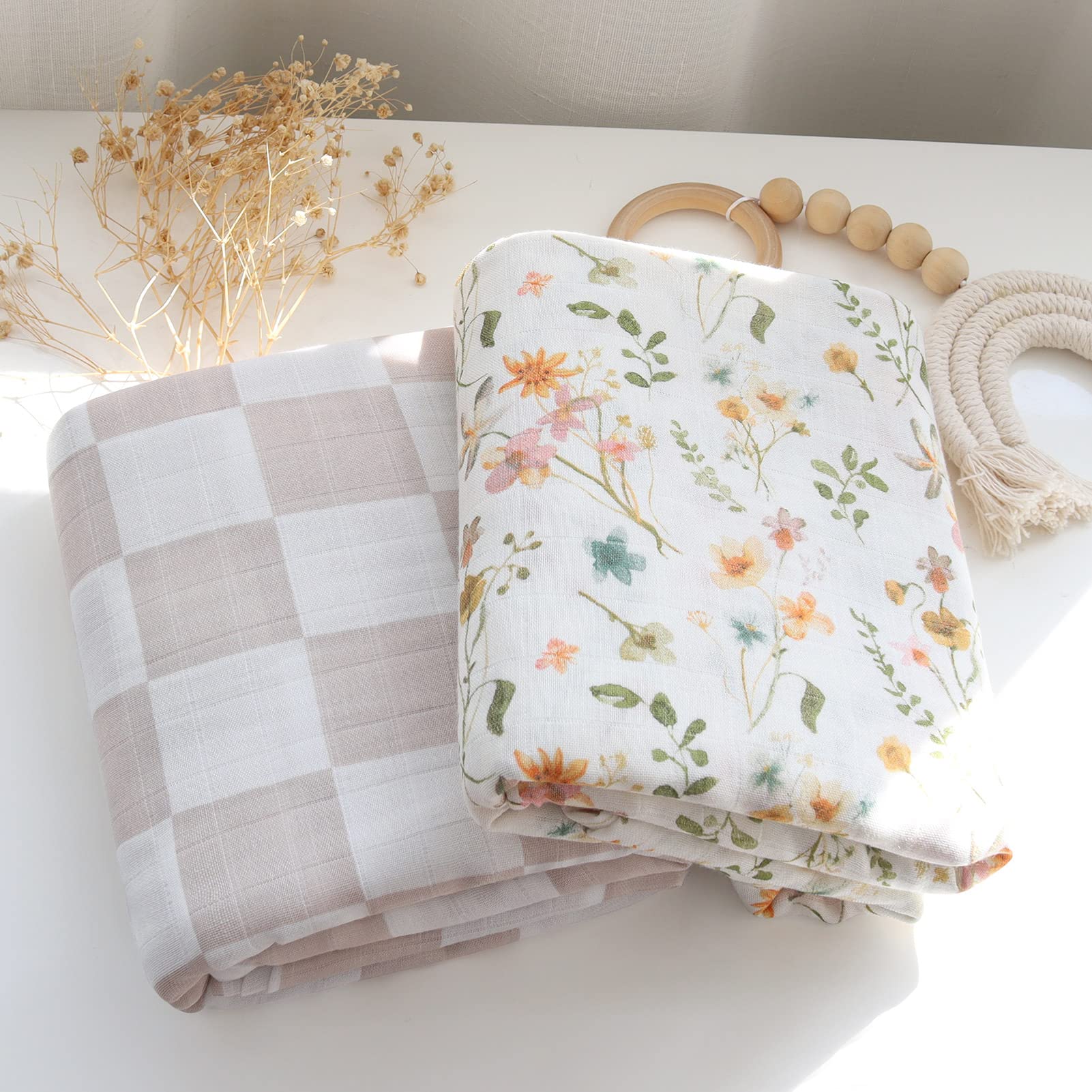 LifeTree Muslin Swaddle Blanket with baby in arms; secure swaddle for peaceful naps