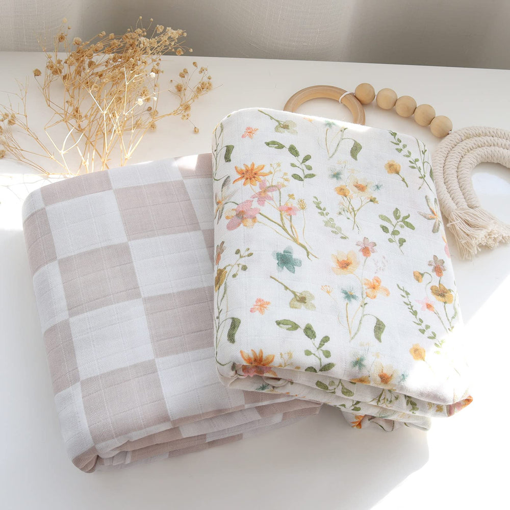 LifeTree Muslin Swaddle Blanket with baby in arms; secure swaddle for peaceful naps