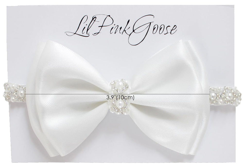 LilPinkGoose newborn headband closeup shows pearl rhinestones and satin bow.