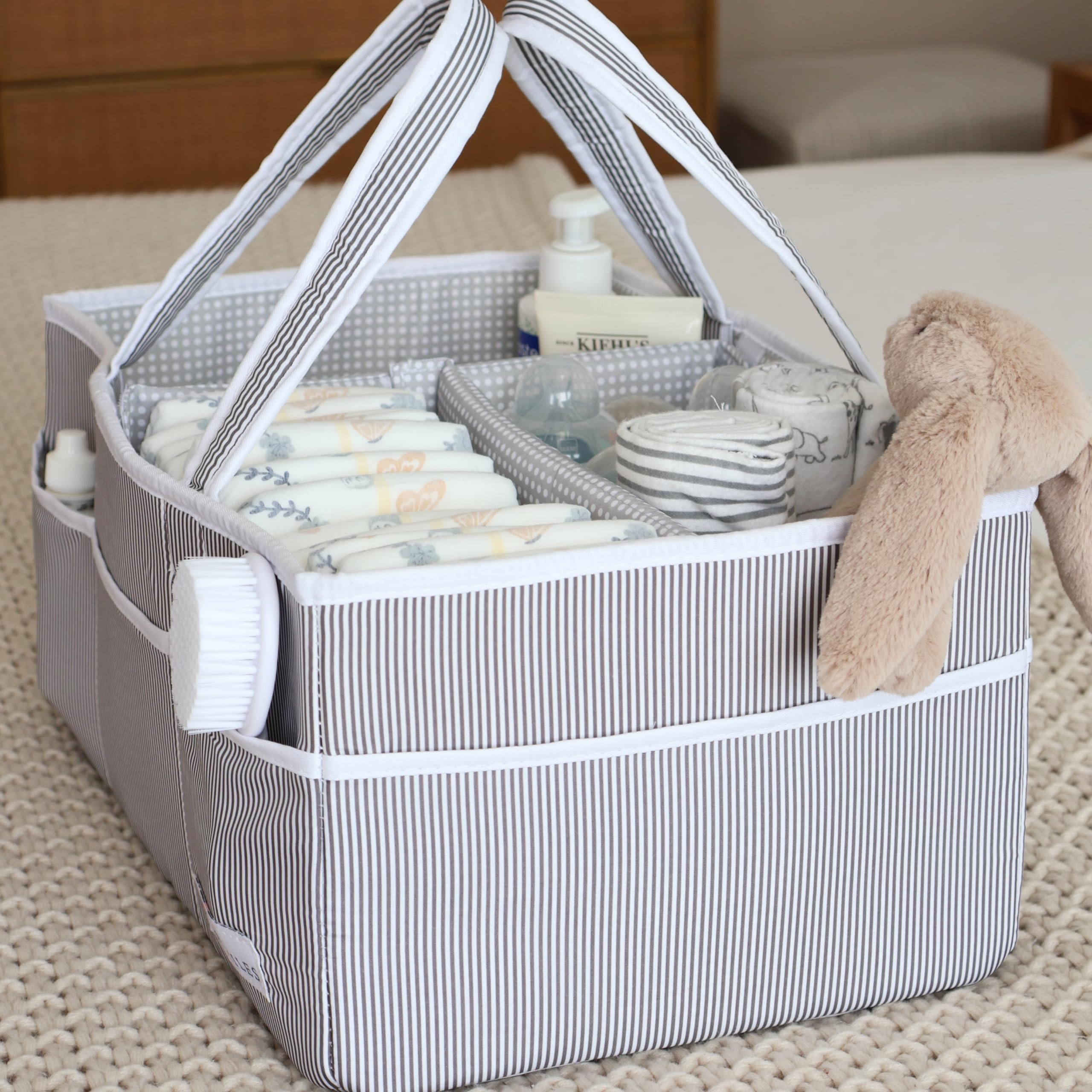 Lily Miles diaper caddy holding diapers and wipes for a ready diapering station.
