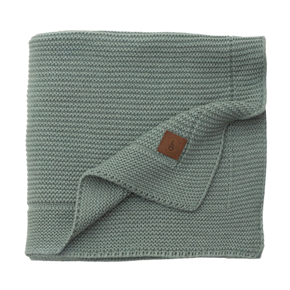 Little Dedi Alina blanket green folded for quick snuggles and compact nursery storage.