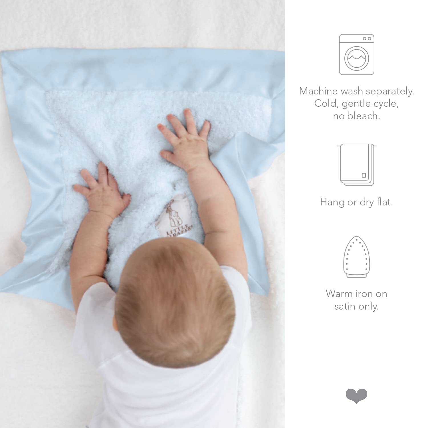 Little Giraffe Blanky blue satin-trim blanket draped over crib edge for nap-time comfort