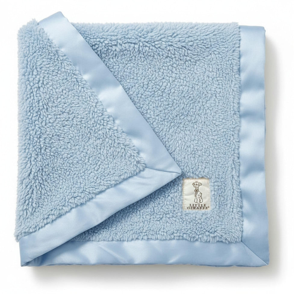Little Giraffe chenille blanket blue folded offers cozy warmth for newborn snuggles.