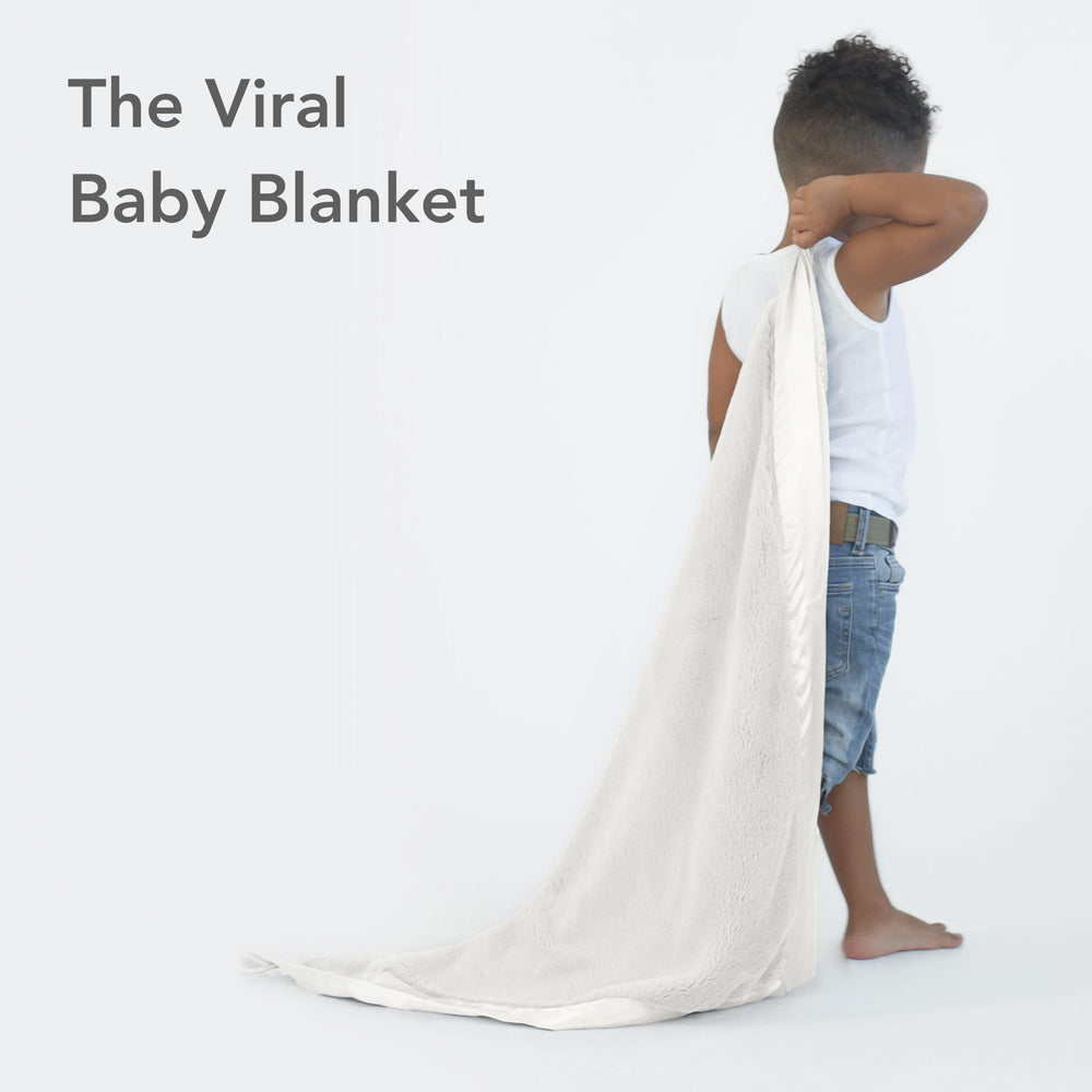 Little Giraffe Posh Mink nursery decor drape adds chic softness to the crib side.