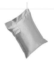 Little Giraffe satin decor pillow in silver with plush feather yarn knit for cozy nursery decor