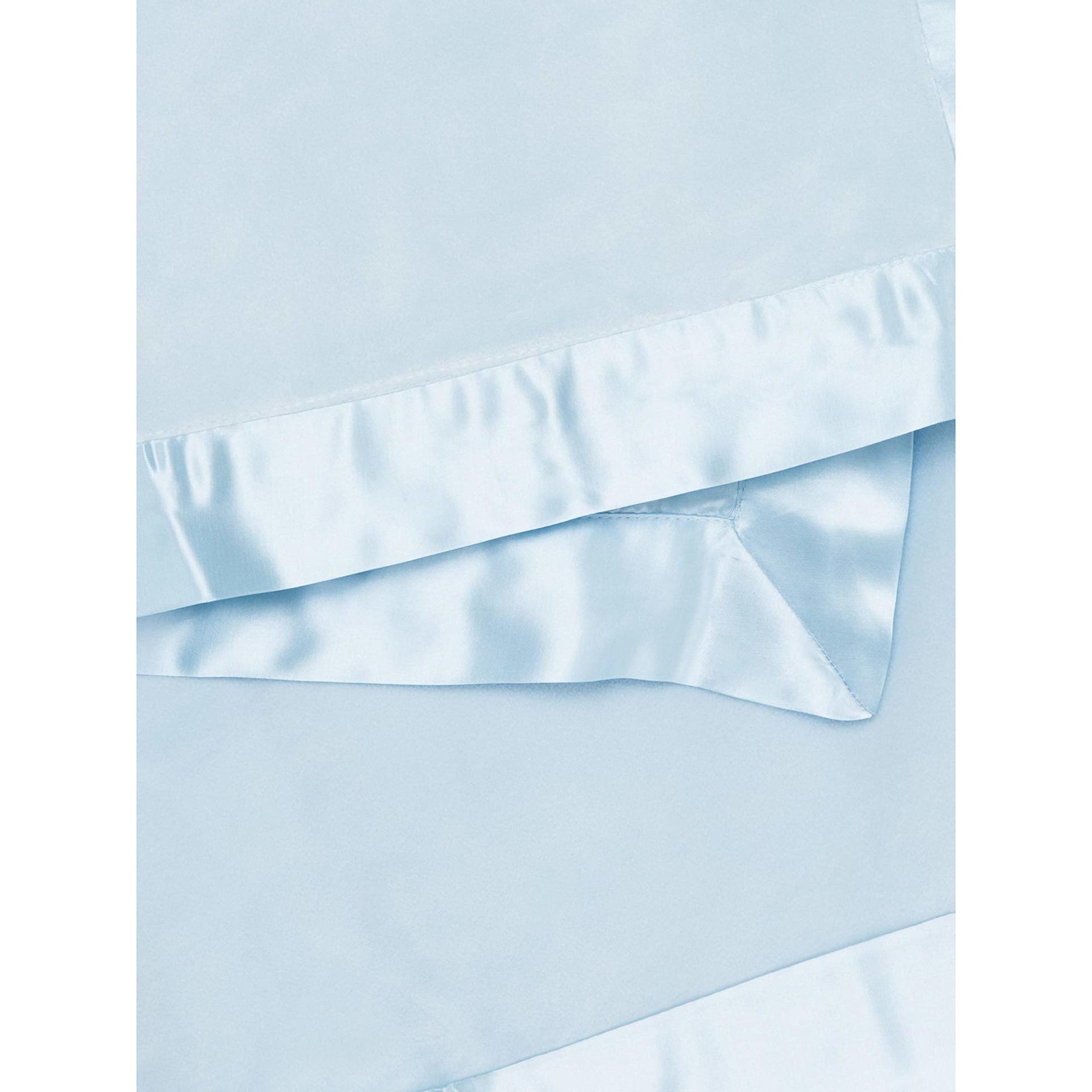Little Giraffe velvet blanket satin trim closeup — luxurious satin detail enhances gentle touch.