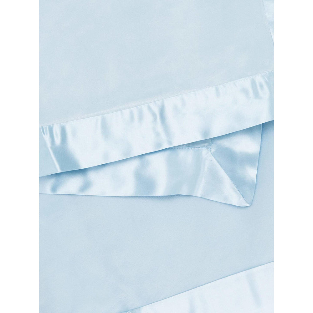 Little Giraffe velvet blanket satin trim closeup — luxurious satin detail enhances gentle touch.