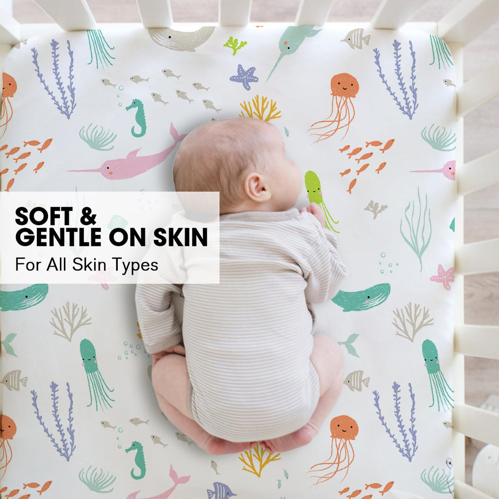 Little Grape Land pastel ocean crib sheet under crib rail, snug fit with 8-inch pocket.