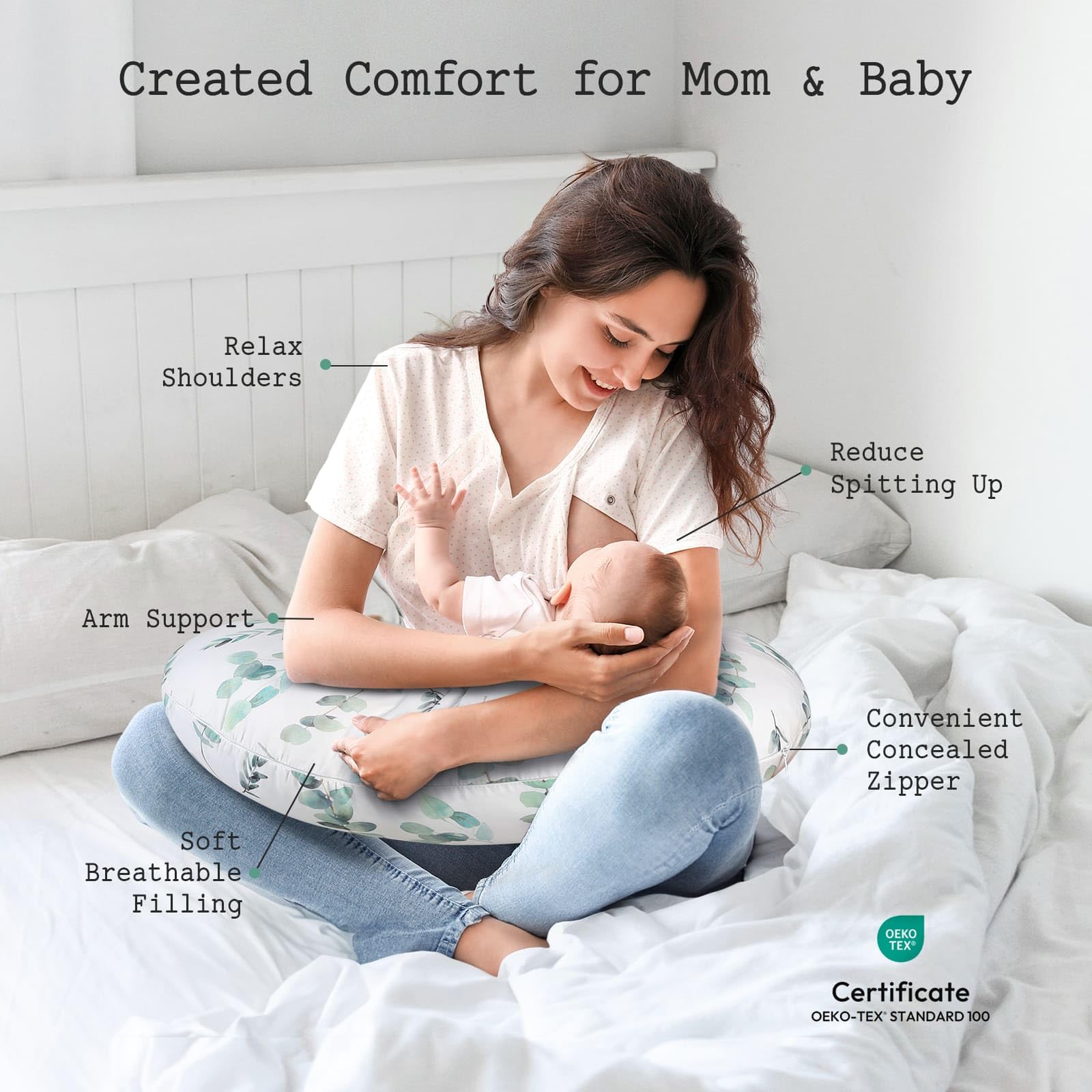 Little Grape Land nursing pillow with green leaves motif demonstrates ergonomic support during feeding.