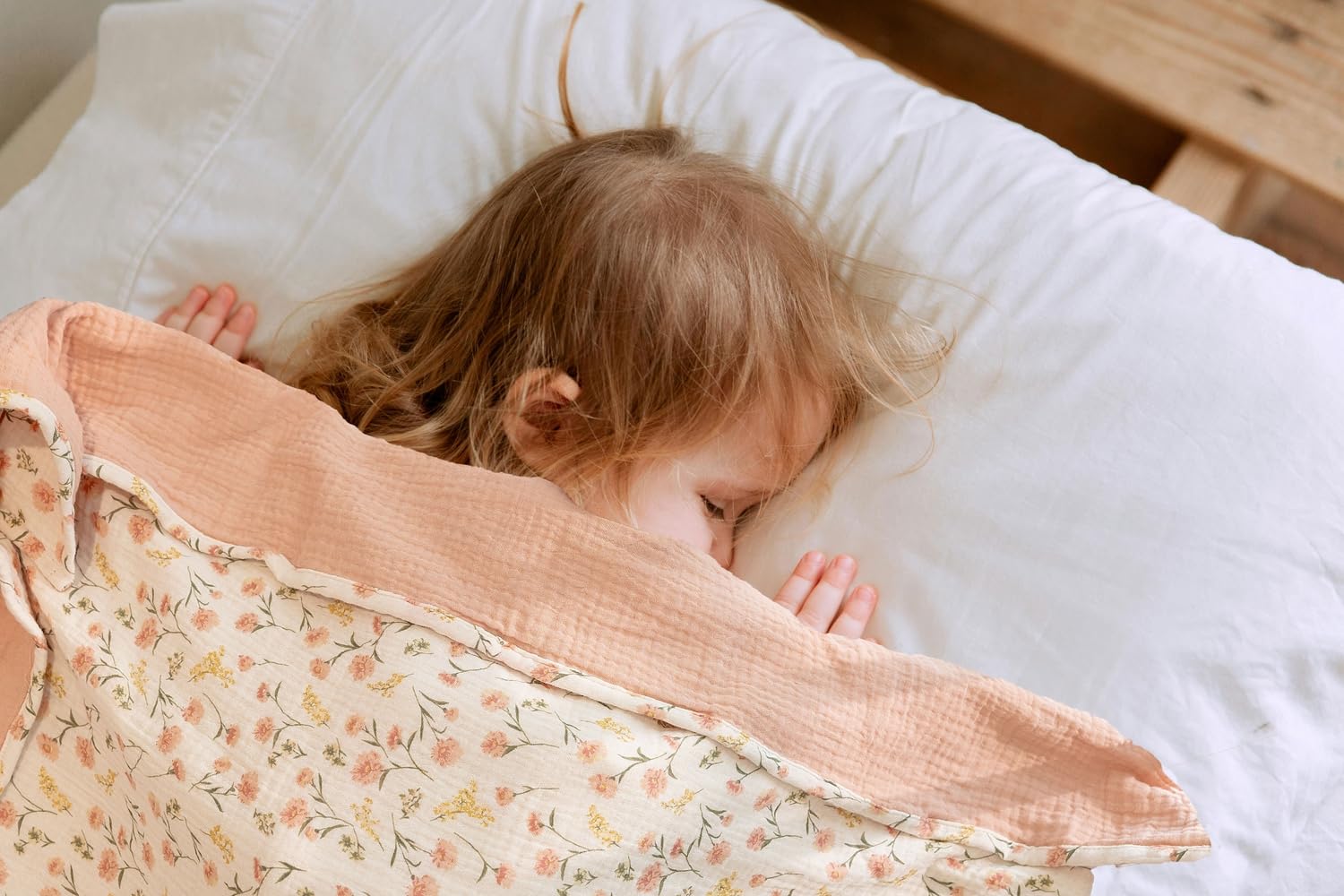 Little Jump muslin blanket peach floral folded highlights versatile coverage for tummy time and stroller trips.