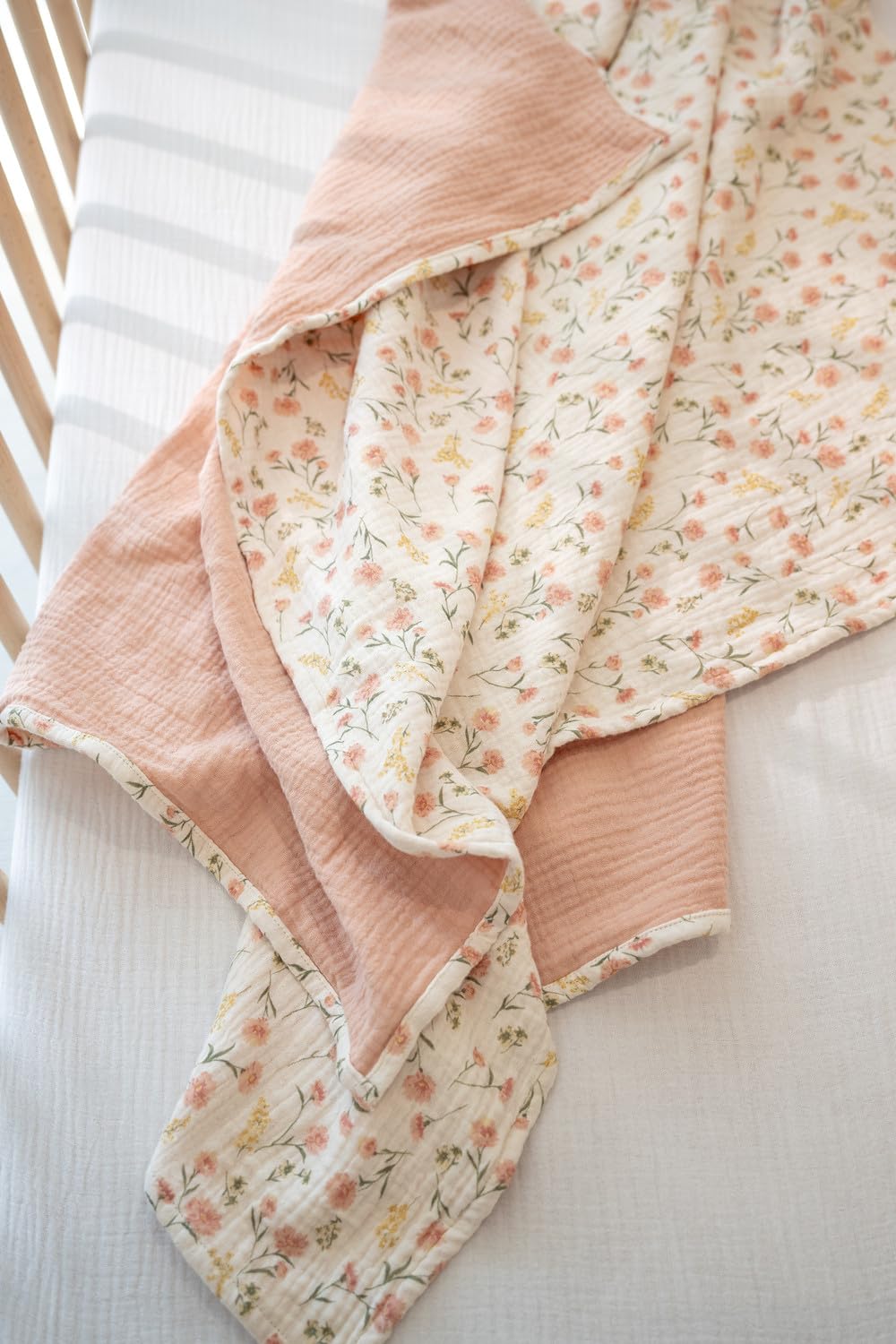 Little Jump muslin blanket soft-texture-detail emphasizes gentle touch against baby's skin.