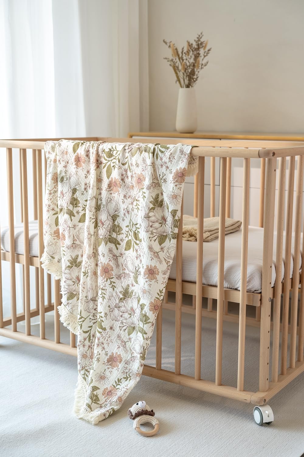 Little Jump muslin blanket close-up with soft tassels for nursery decor.