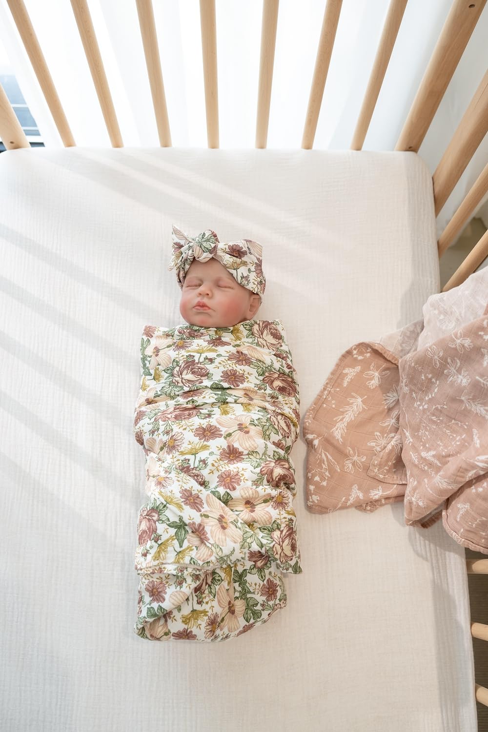 Little Jump Western Wild Flowers pattern on a swaddle for stylish nursery photos.