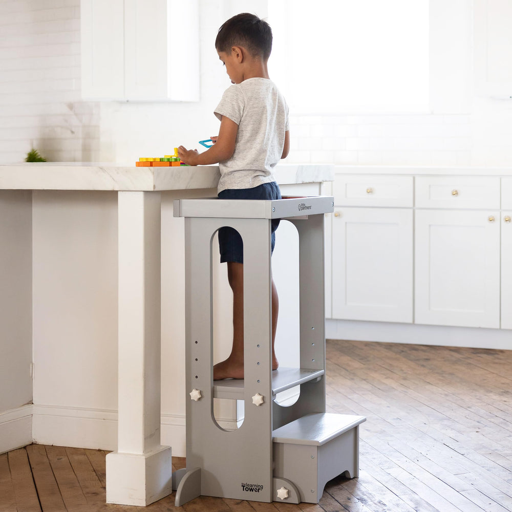 Little Partners Learning Tower kitchen setup demonstrates early independence with supervision.