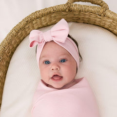 Little Sleepies swaddle Prima Pink used as stroller shade during sunny outings