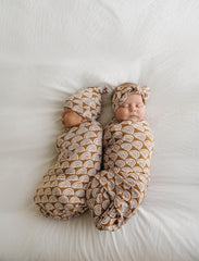 little sleepies rust rainbows swaddle used as stroller shade in bright day