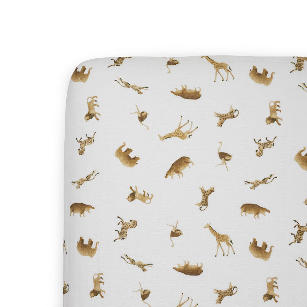 Little Unicorn Animal Crackers crib sheet folded, showcasing soft organic cotton for gentle sleep.