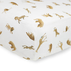 Little Unicorn Animal Crackers crib sheet on mattress, breathable muslin helps regulate baby's temperature.
