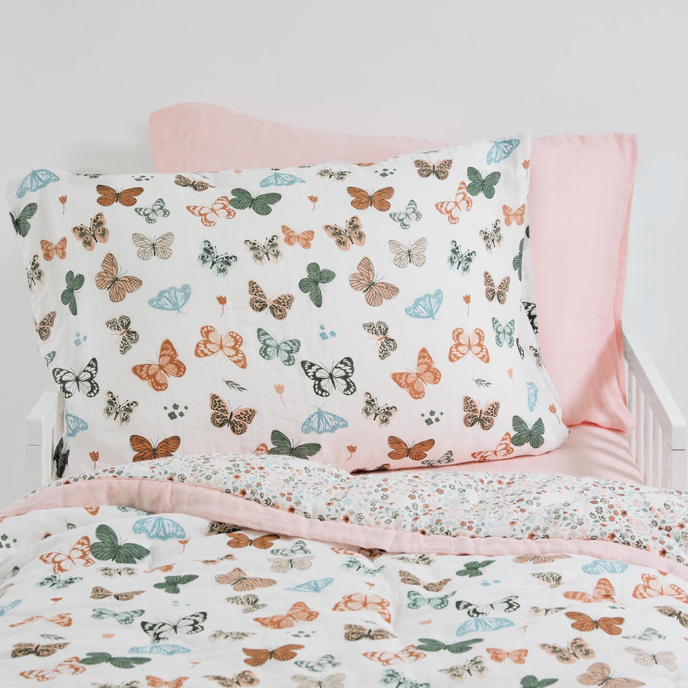 Little Unicorn butterflies 2-pack pillowcase closeup shows soft muslin texture.