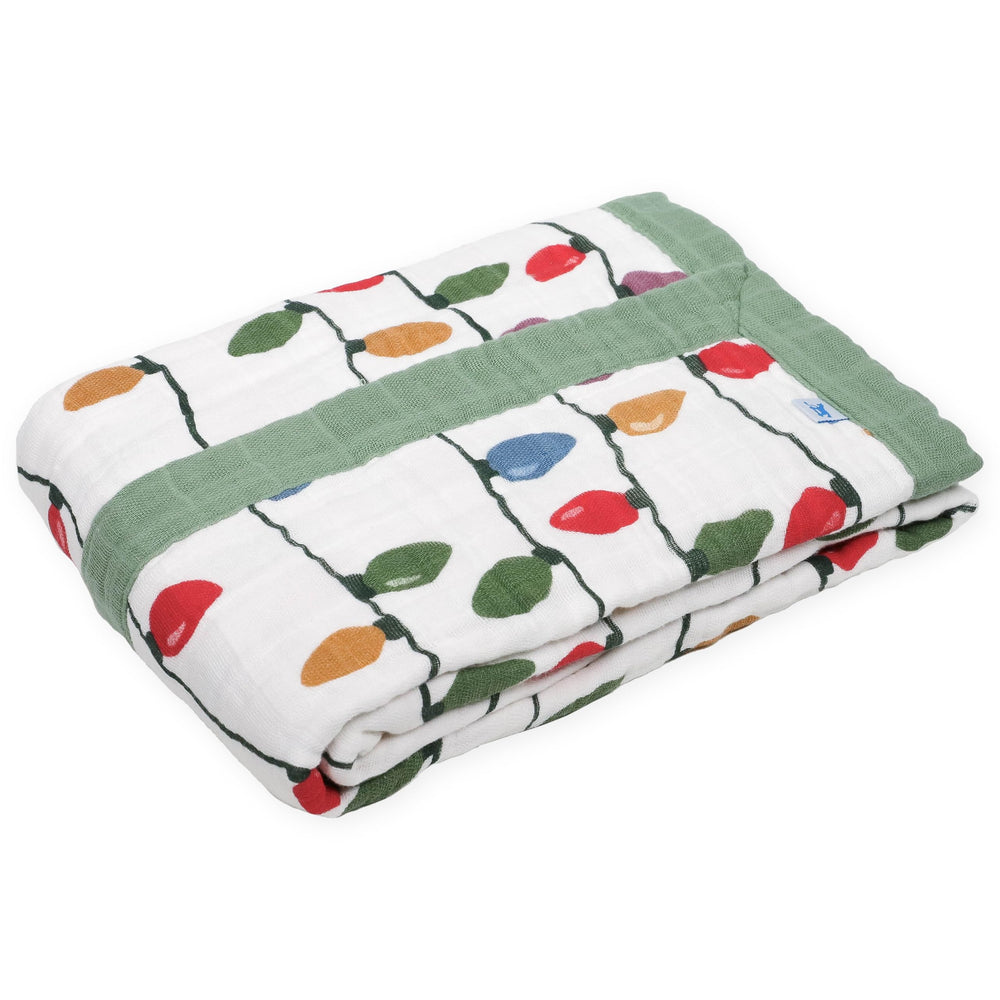 Little Unicorn cotton muslin quilt with hand-painted prints delivers breathable warmth for naps.