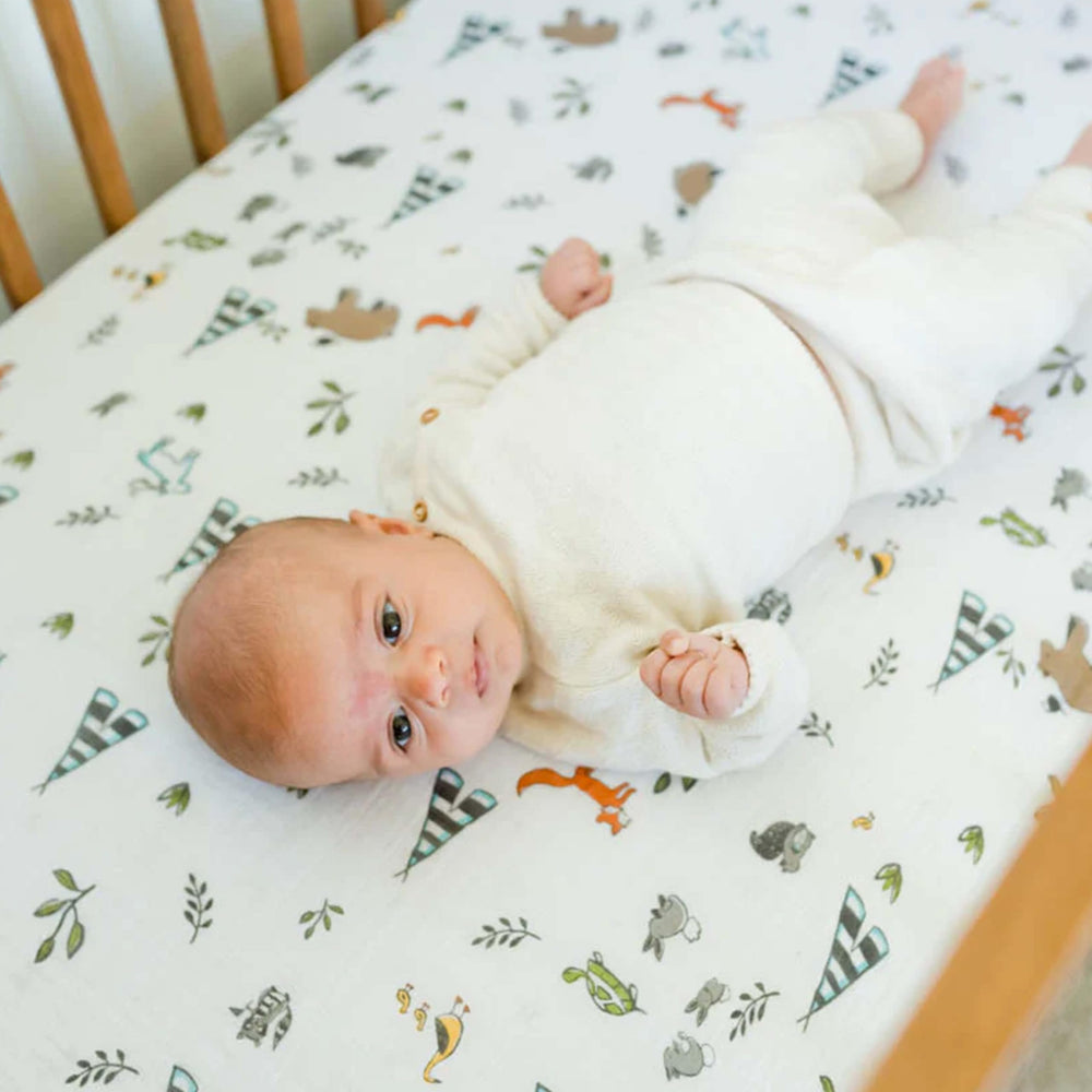 Little Unicorn Forest Friends elastic edge-fit ensuring snug bedding.