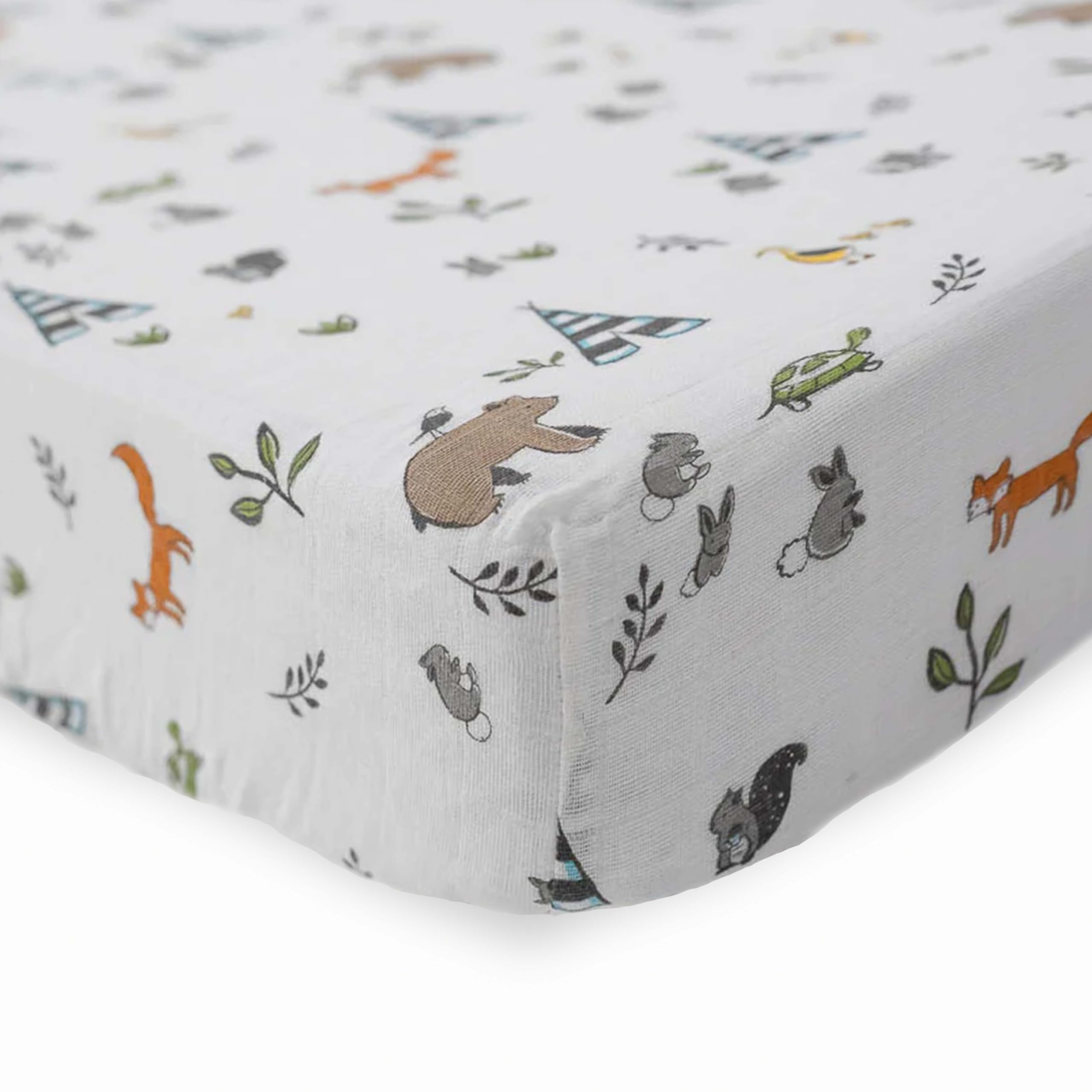 Little Unicorn Forest Friends crib sheet on mattress displaying breathable muslin comfort.