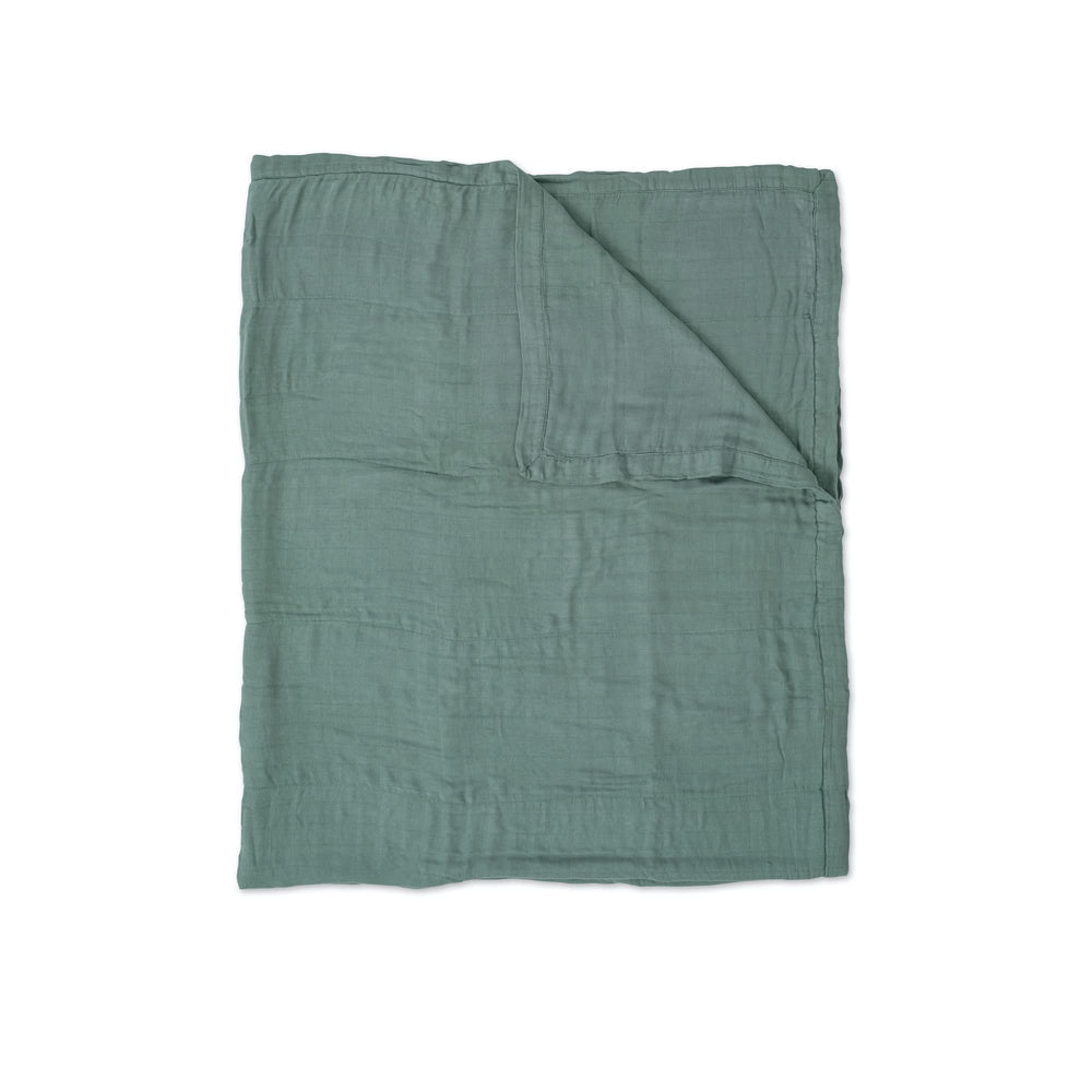 Little Unicorn Deluxe Muslin Quilt in stroller nap demonstrates lightweight, breathable coverage for on-the-go rest.