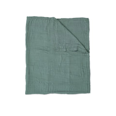 Little Unicorn Deluxe Muslin Quilt in stroller nap demonstrates lightweight, breathable coverage for on-the-go rest.