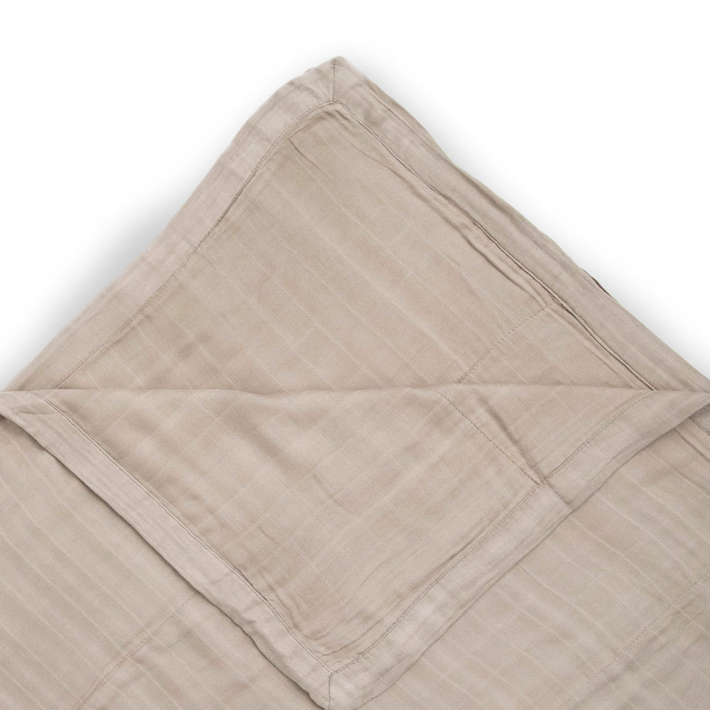 Little Unicorn Deluxe Muslin Quilt used for baby snuggle moments.