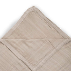 Little Unicorn Deluxe Muslin Quilt used for baby snuggle moments.