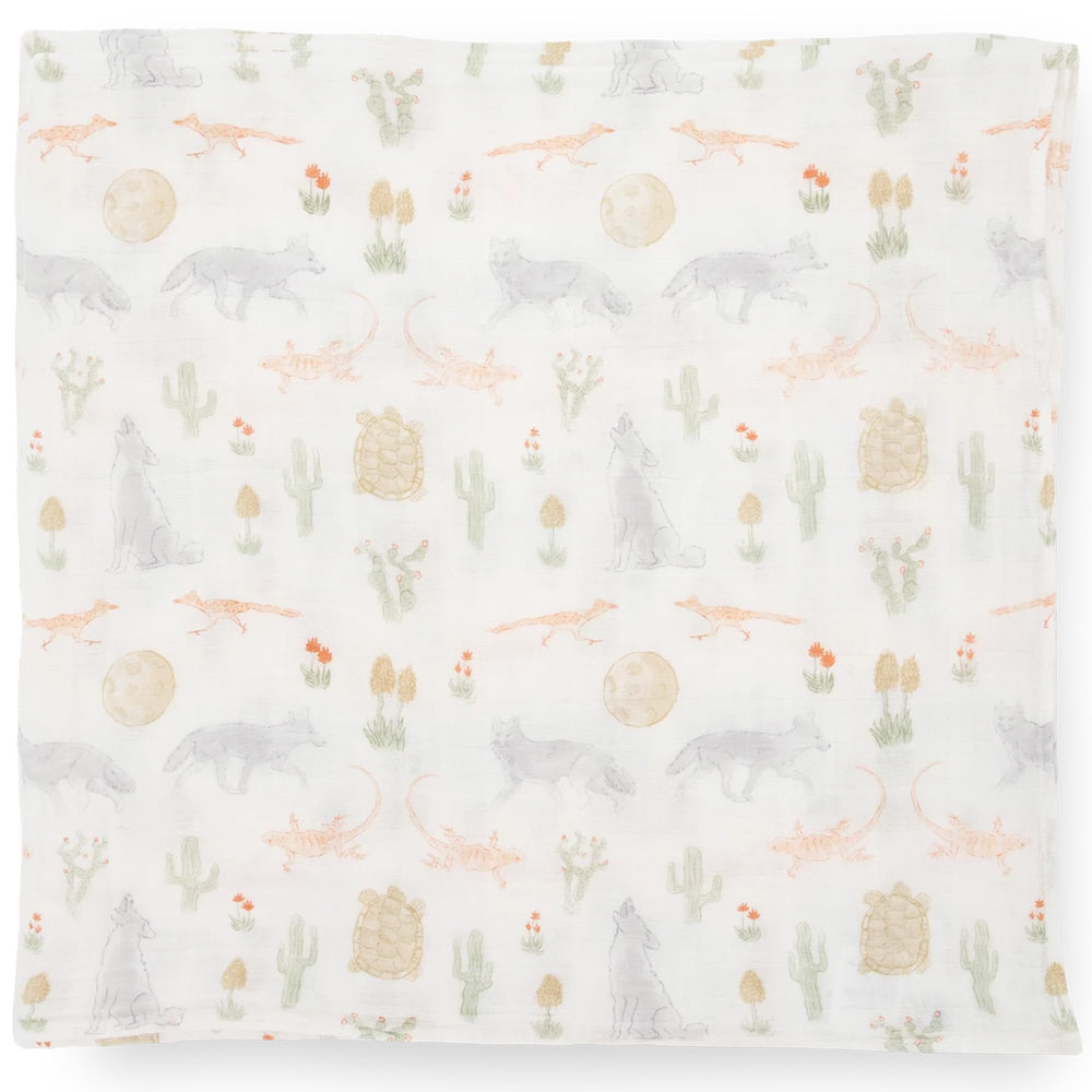 Little Unicorn Desert Night swaddle used for nursing setup and easy access.