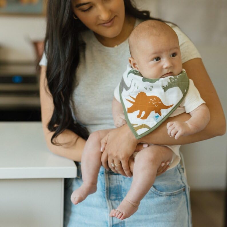 Little Unicorn Dino Friends bib worn on baby demonstrates gentle contour and skin-friendly design.