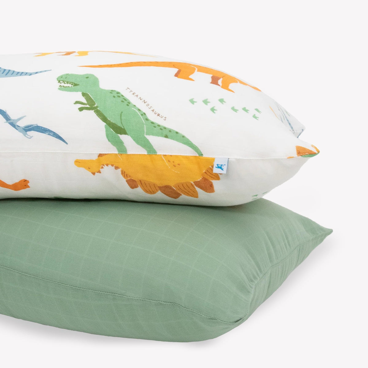 Little Unicorn dino names pillowcase close-up highlights plush muslin for cozy, breathable kid sleep
