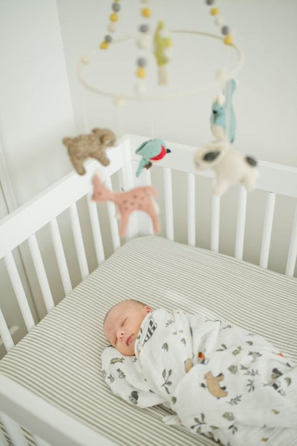Little Unicorn Forest Friends swaddle used for nursing moments with soft fabric