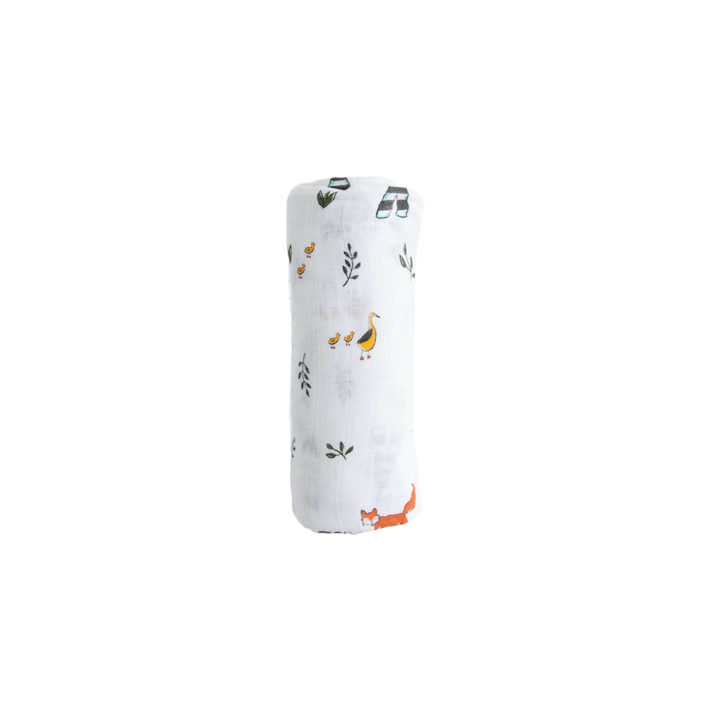 Little Unicorn Forest Friends swaddle care tag indicating machine washability