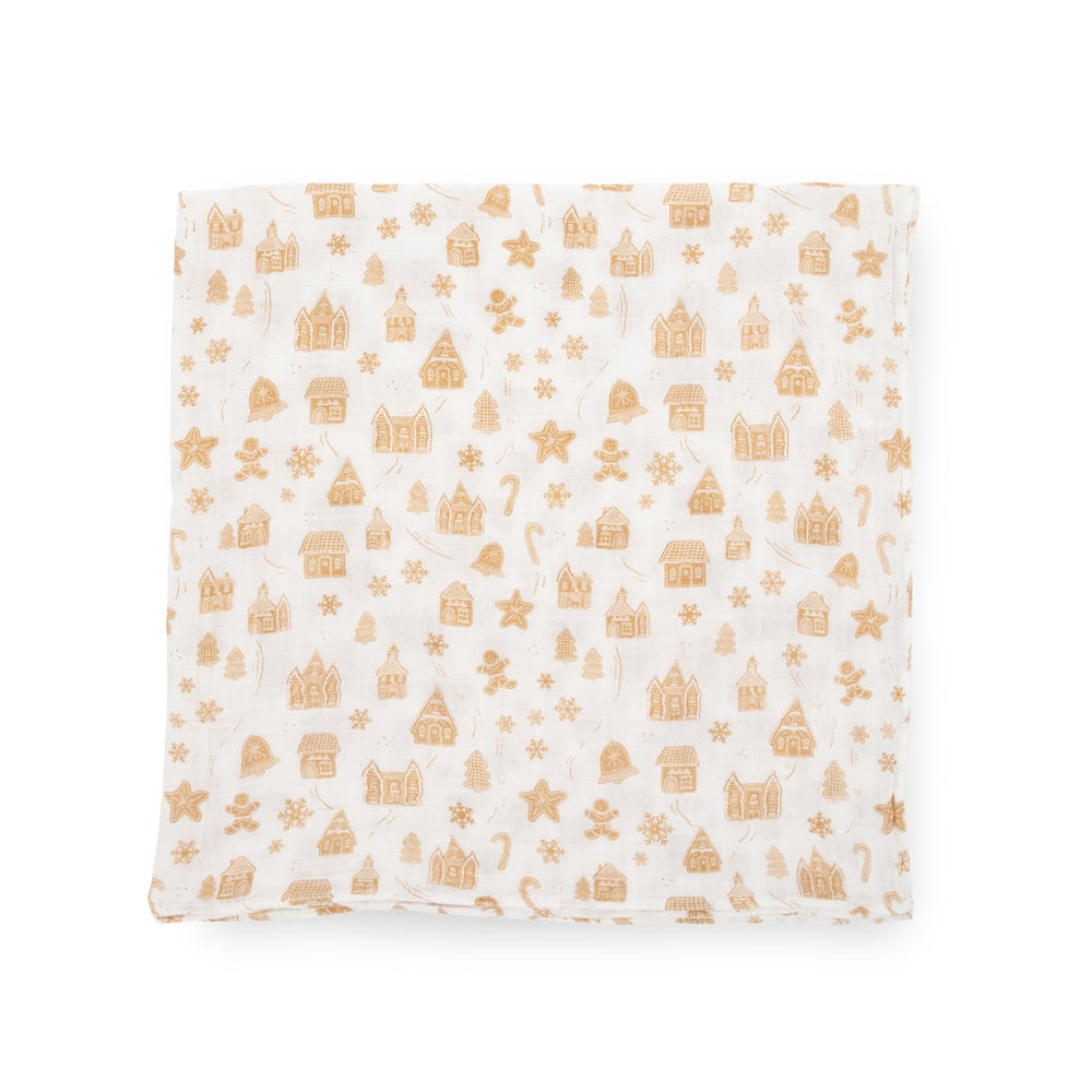 Little Unicorn Gingerbread Village stroller cover illustrates portable blanket for on-the-go comfort.