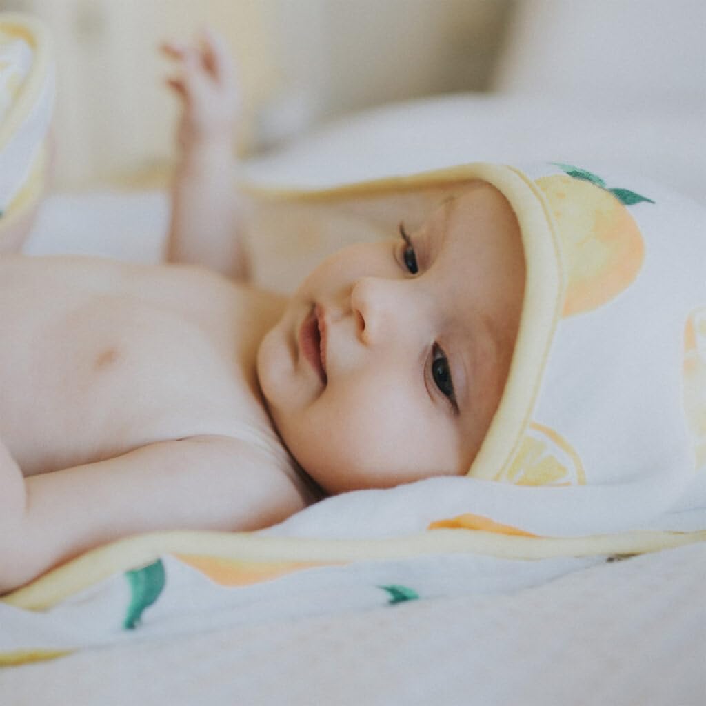 Little Unicorn lemon towel wrapped around baby demonstrates gentle secure bath-time drying.