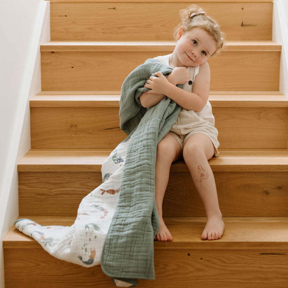 Little Unicorn mermaids quilt in stroller or crib-ready size for on-the-go comfort.