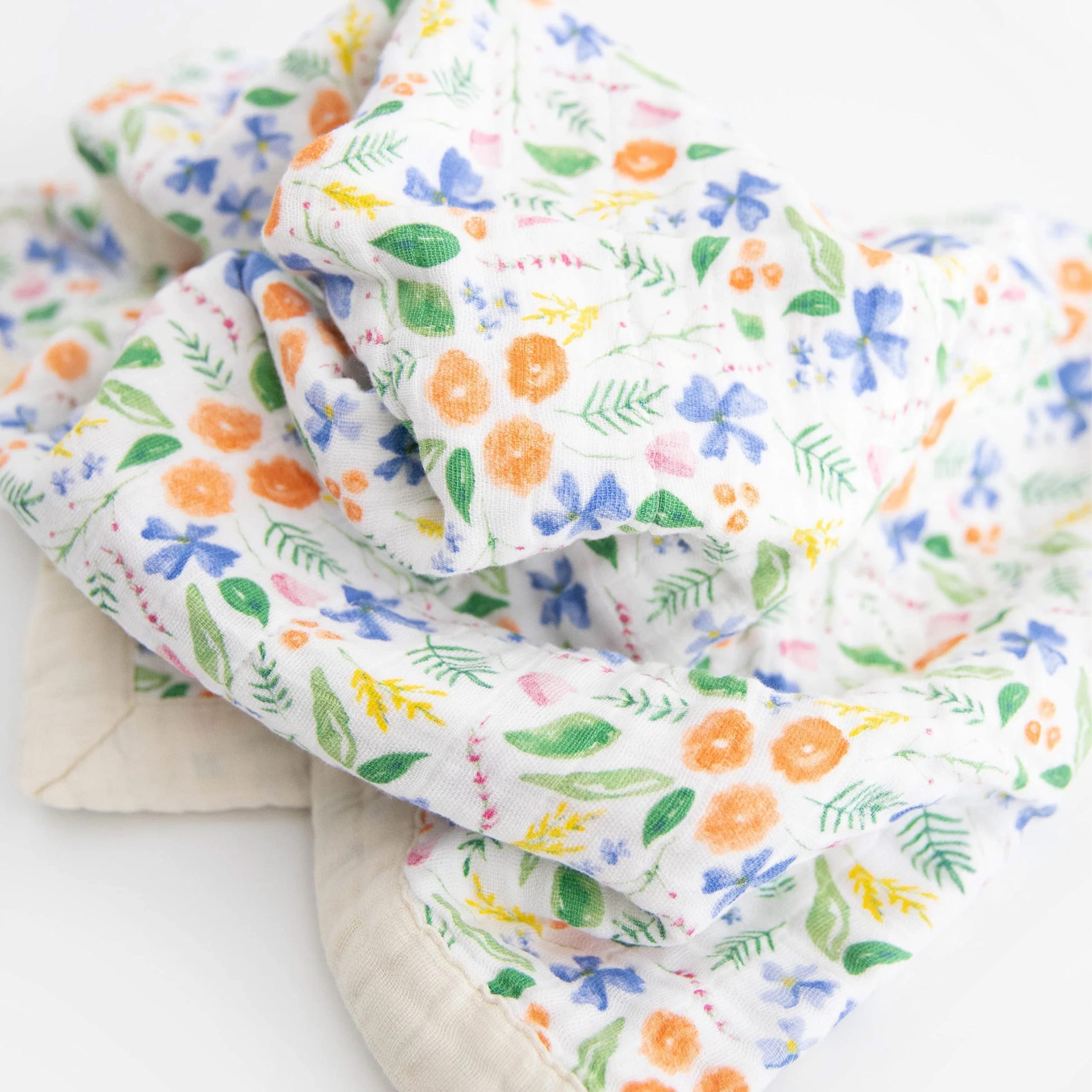 Little Unicorn newborn receiving quilt four-layer muslin closeup highlights breathable fabric and durable stitching.