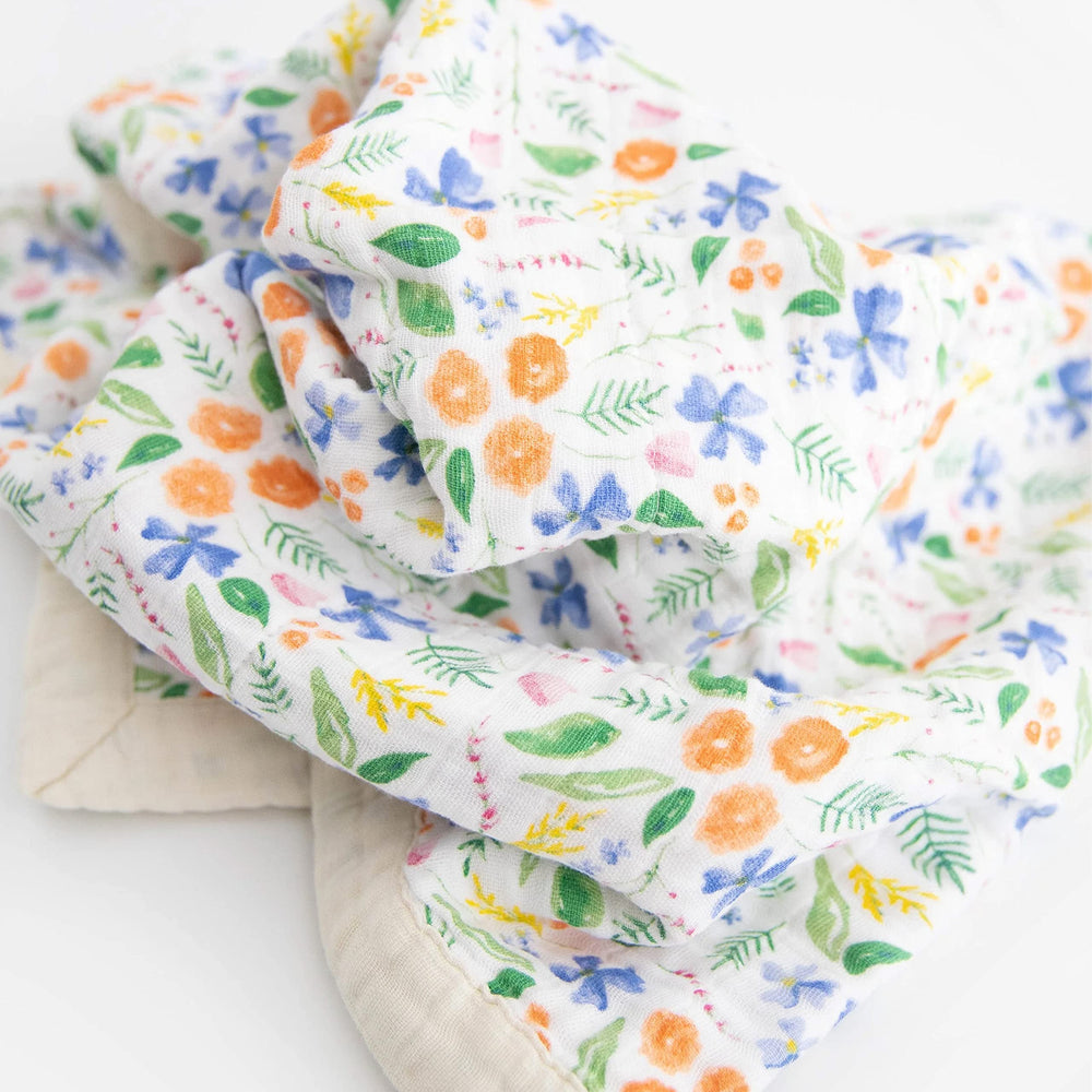 Little Unicorn newborn receiving quilt four-layer muslin closeup highlights breathable fabric and durable stitching.