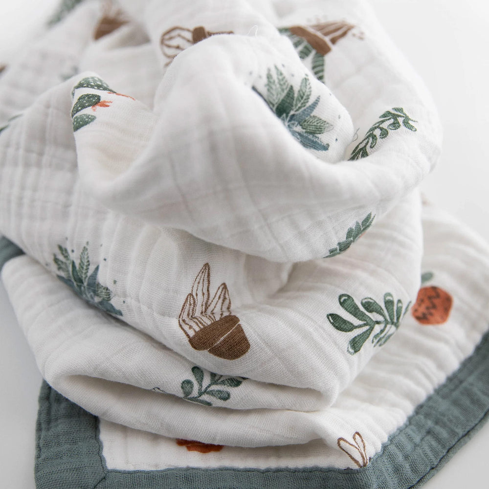 Little Unicorn newborn quilt folded compactly for easy travel on the go.