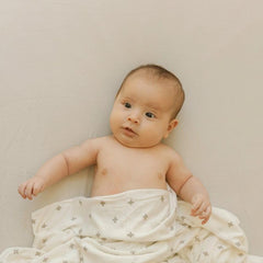 Little Unicorn Pebble stretch knit crib sheet with corner elastic for secure fit.