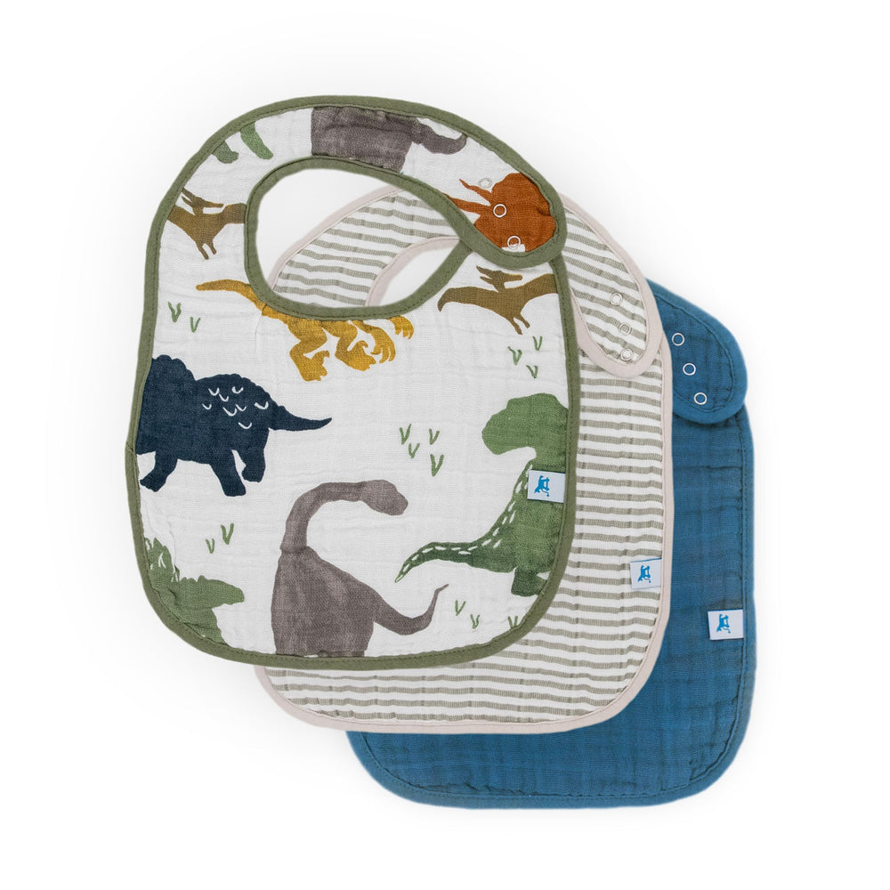 Little Unicorn Premium Classic Bib Dino Friends 2 folded, showcasing soft muslin for gentle everyday feeding.