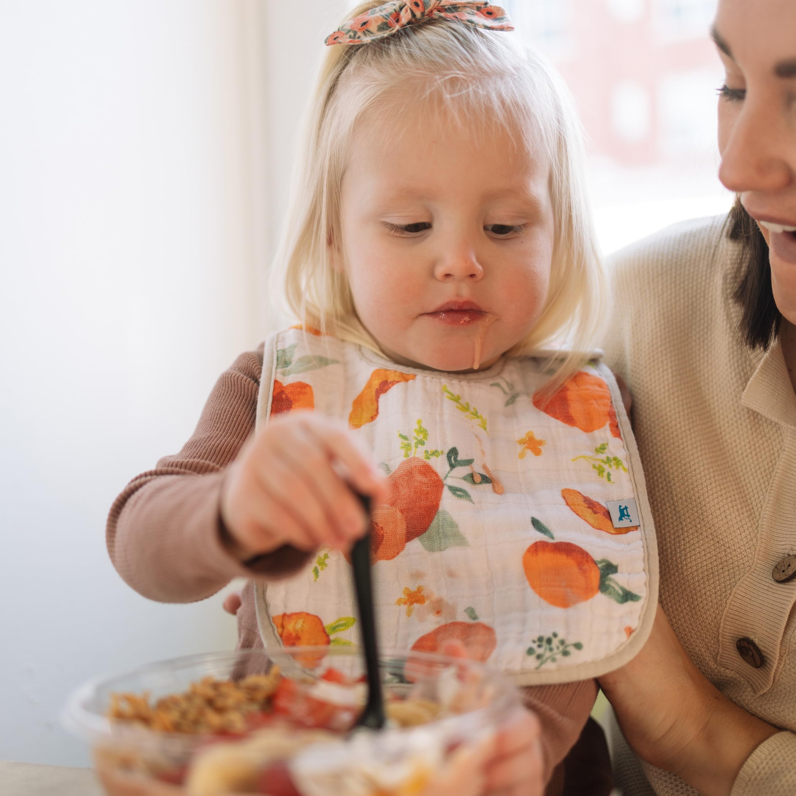 Little Unicorn Premium Classic Bib in-use during meals helps keep clothes cleaner and easier cleanup