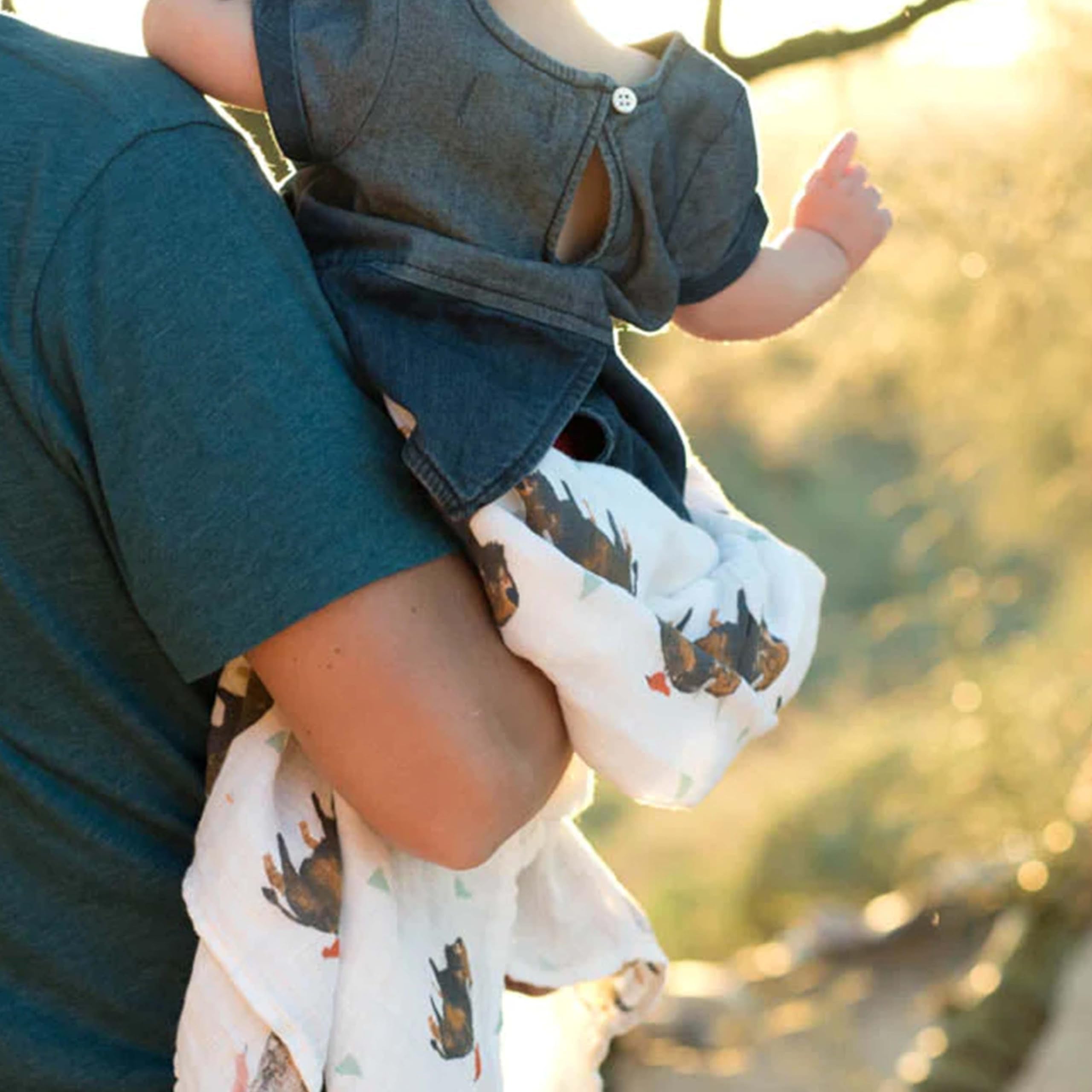 Little Unicorn blanket draped over chair showcasing versatile use for nursing and cuddling.