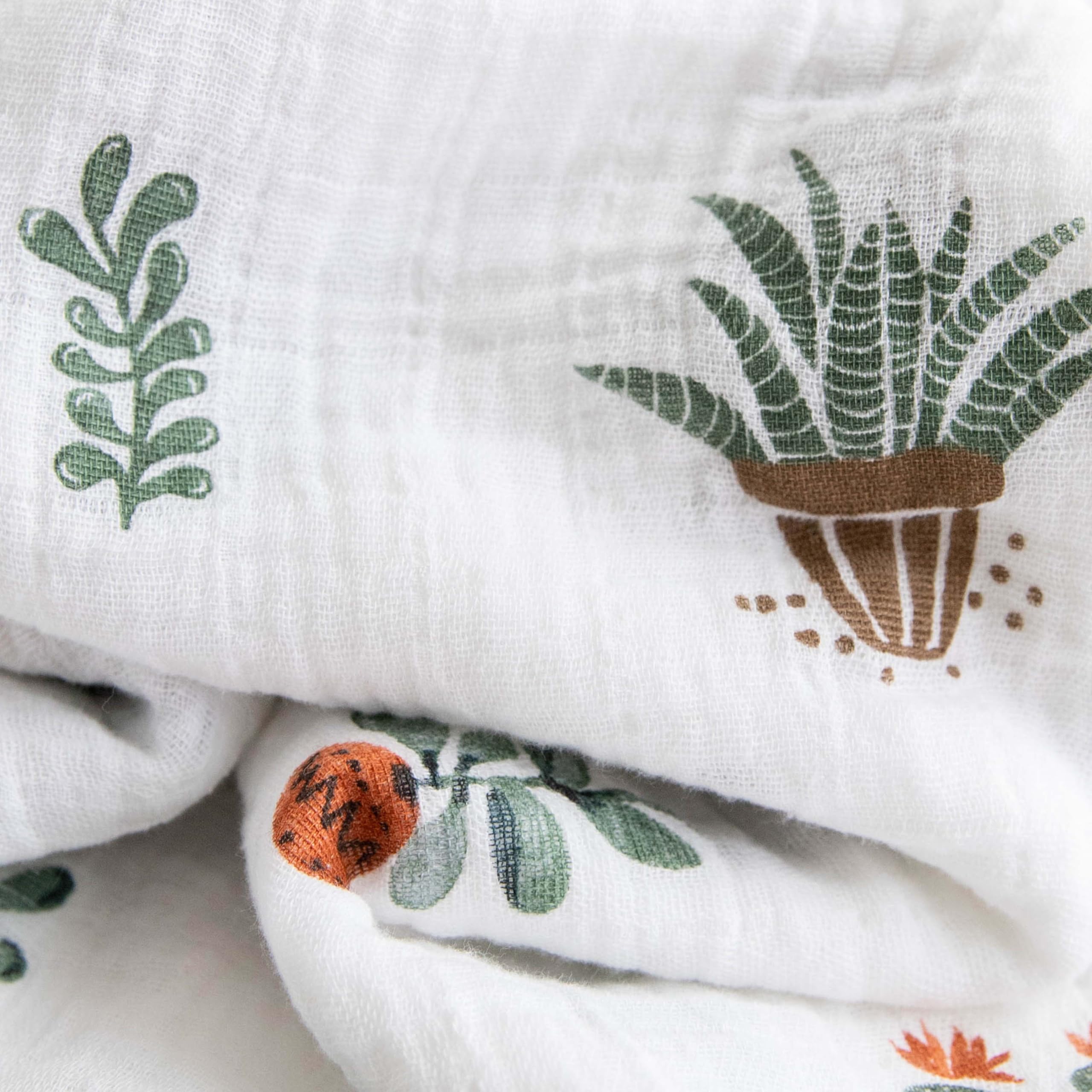 Little Unicorn premium cotton swaddle blanket showing 47x47 swaddle size for secure wrap.