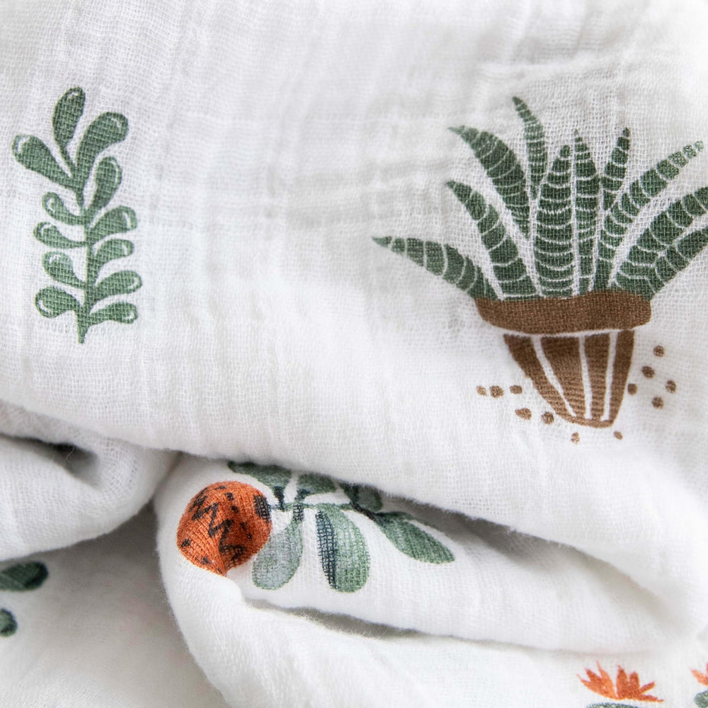 Little Unicorn premium cotton swaddle blanket showing 47x47 swaddle size for secure wrap.