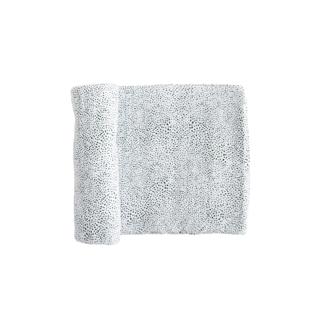 Little Unicorn swaddle close-up texture showing breathable cotton muslin.