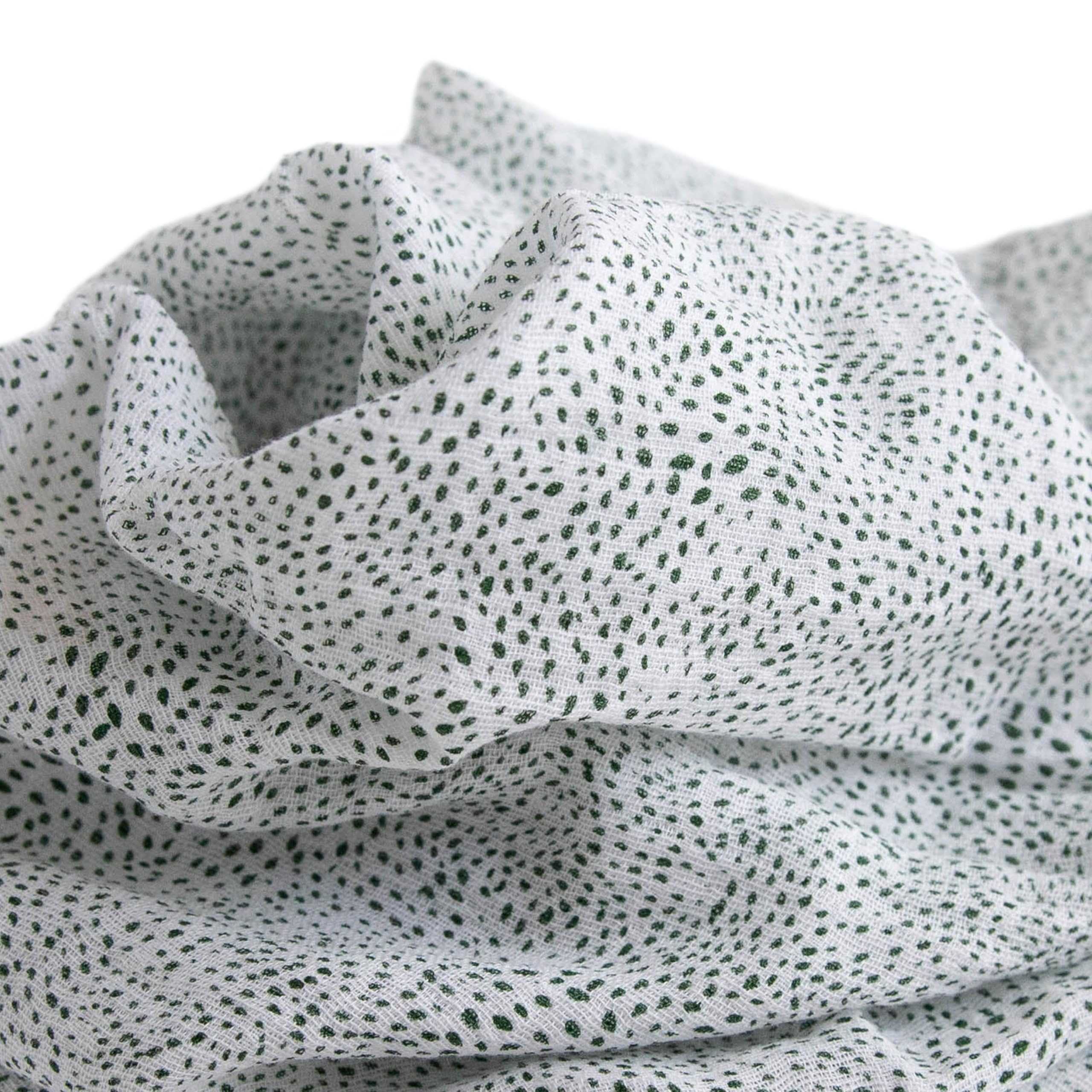 Little Unicorn swaddle Green Seed galaxy design laid flat for soothing style.